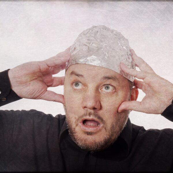 paranoid-man-with-tin-foil-hat-conspiracy-theories