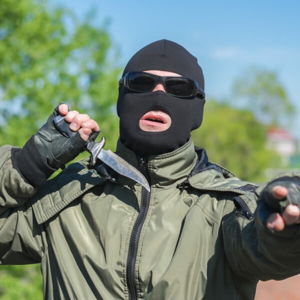 masked-bandit-shows-threatening-gestures-