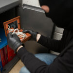 thief-stealing-valuables-from-safe-at-crime-scene