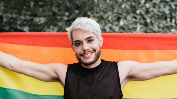 drag-queen-holding-lgbtq-rainbow-flag-outdoor