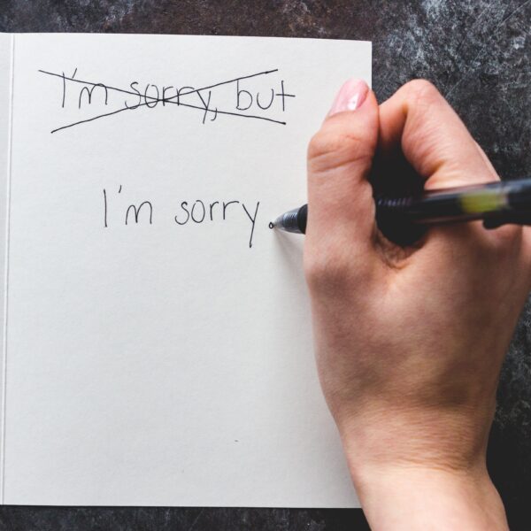 person-writing-sorry-not-sorry